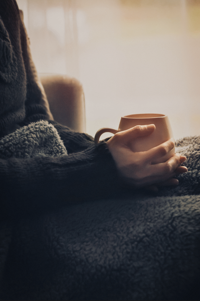 Self Portrait with tea Holding a cup of hot tea relaxing in a calm and warm room.